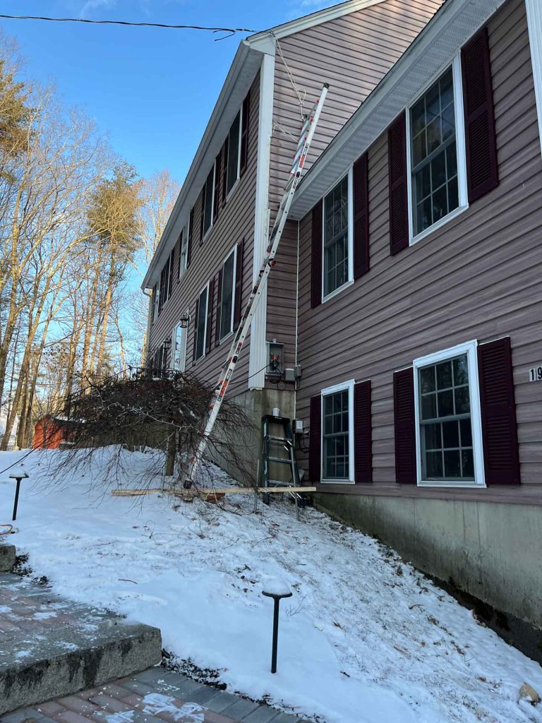 Exterior of house with ladder up to roof